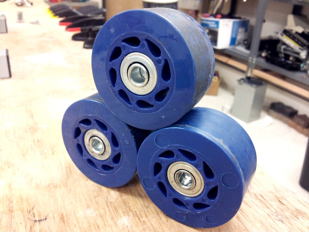 Gros plan sur trois roues de skateboard en polyuréthane avec leurs roulements