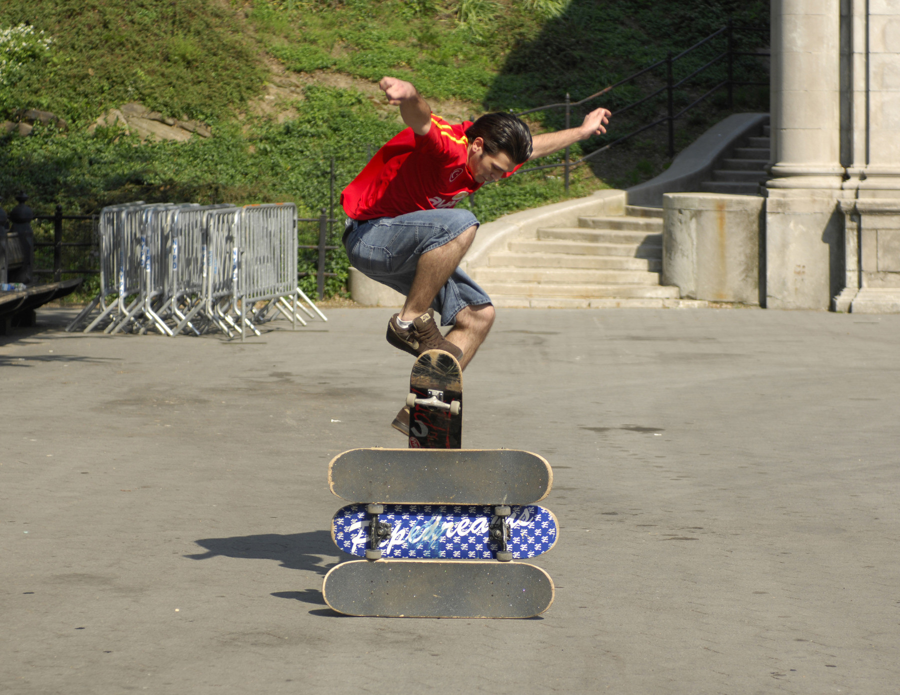 Un skateur passe un ollie au-dessus de trois planches empilées, sans juge et sans tribune — le skate de rue que filmait Emerica