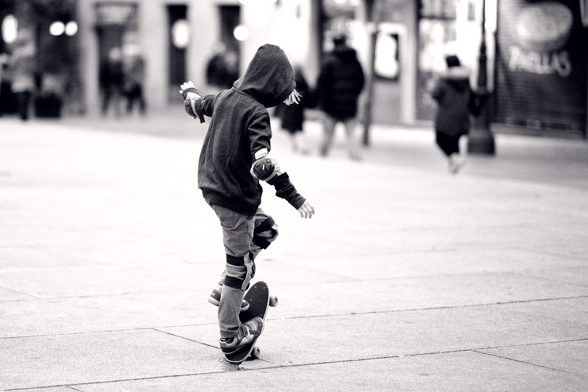 Un enfant apprend seul sur sa planche au milieu d’une place, comme Lucie Schoonheere à 8 ans en suivant son grand frère