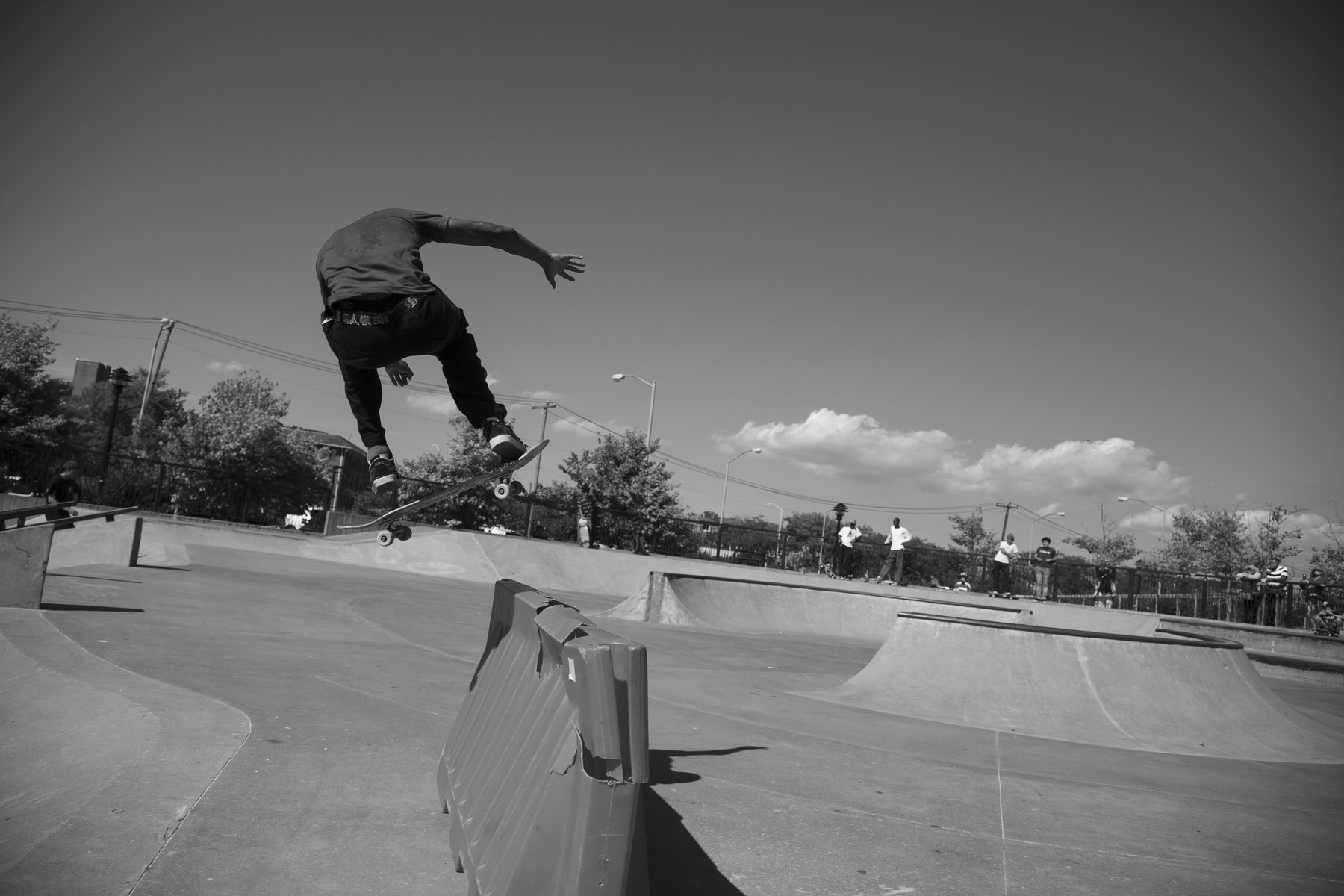 Skateur passant un ollie au-dessus d'une barrière de chantier au Far Rockaway Skatepark